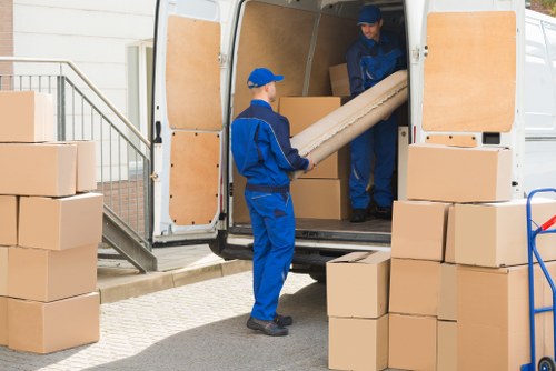 Removal van loading household items on a residential Ealing street