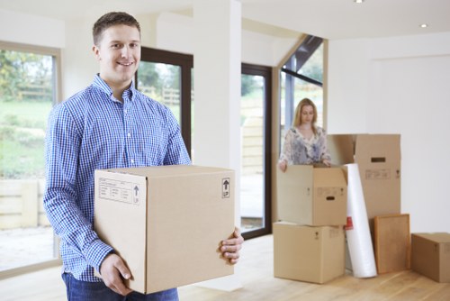 Professional movers unloading items at an Ealing property