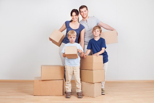Unpacking boxes in a bright Ealing apartment after moving day