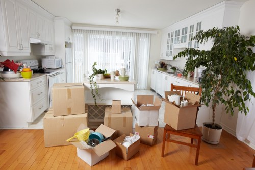 Local movers carrying furniture during a home removal in Ealing