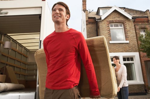Professional movers handling furniture in a local Ealing property
