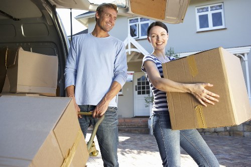 Professional helpers carrying boxes during an Ealing flat move