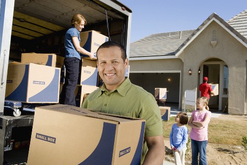 Packed household boxes and furniture for transport in West London