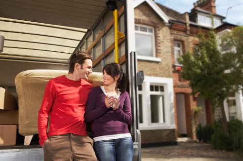 Removal team handling furniture on a local West London street
